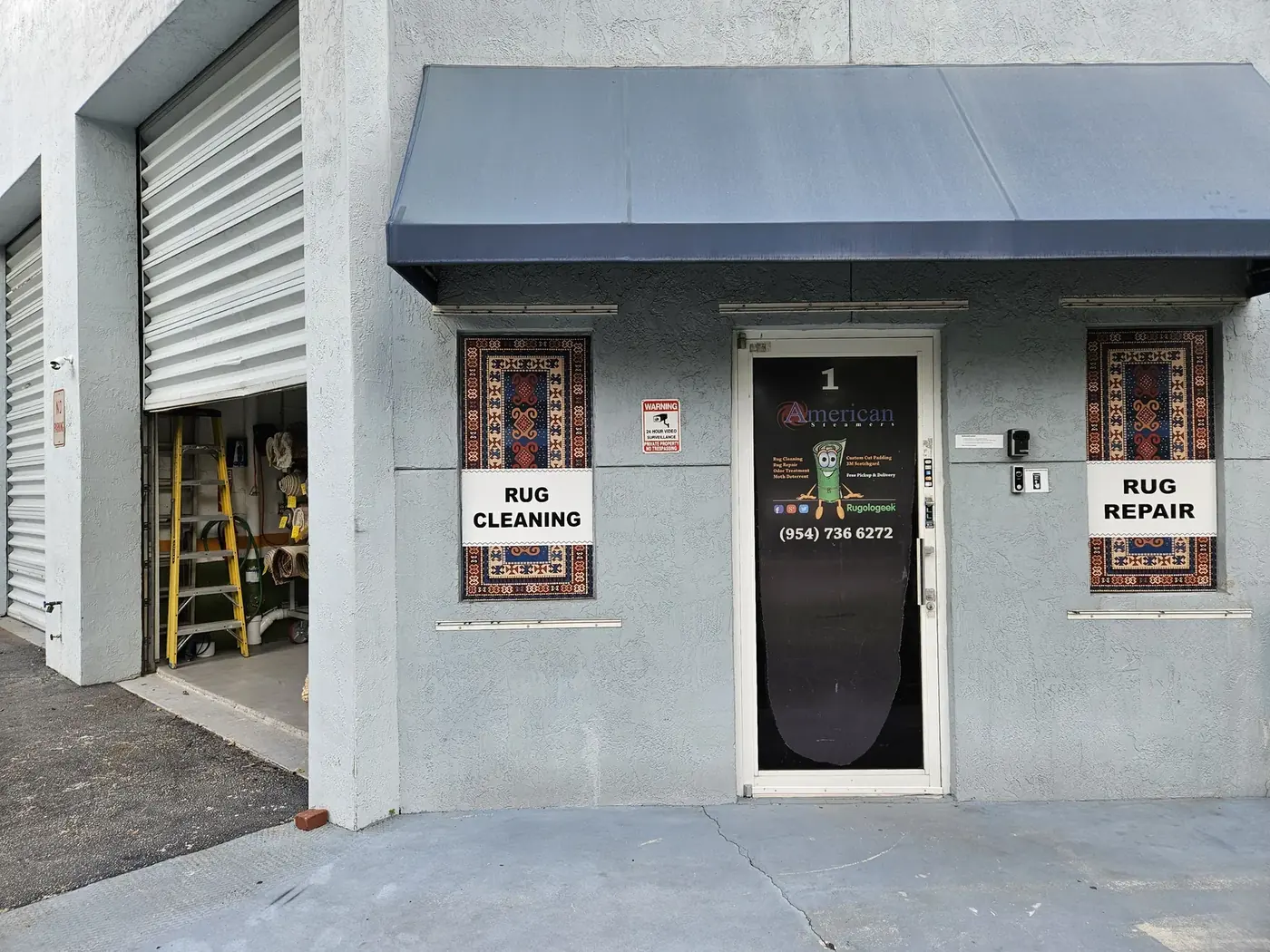 Shop entrance with rug cleaning and rug repair signage