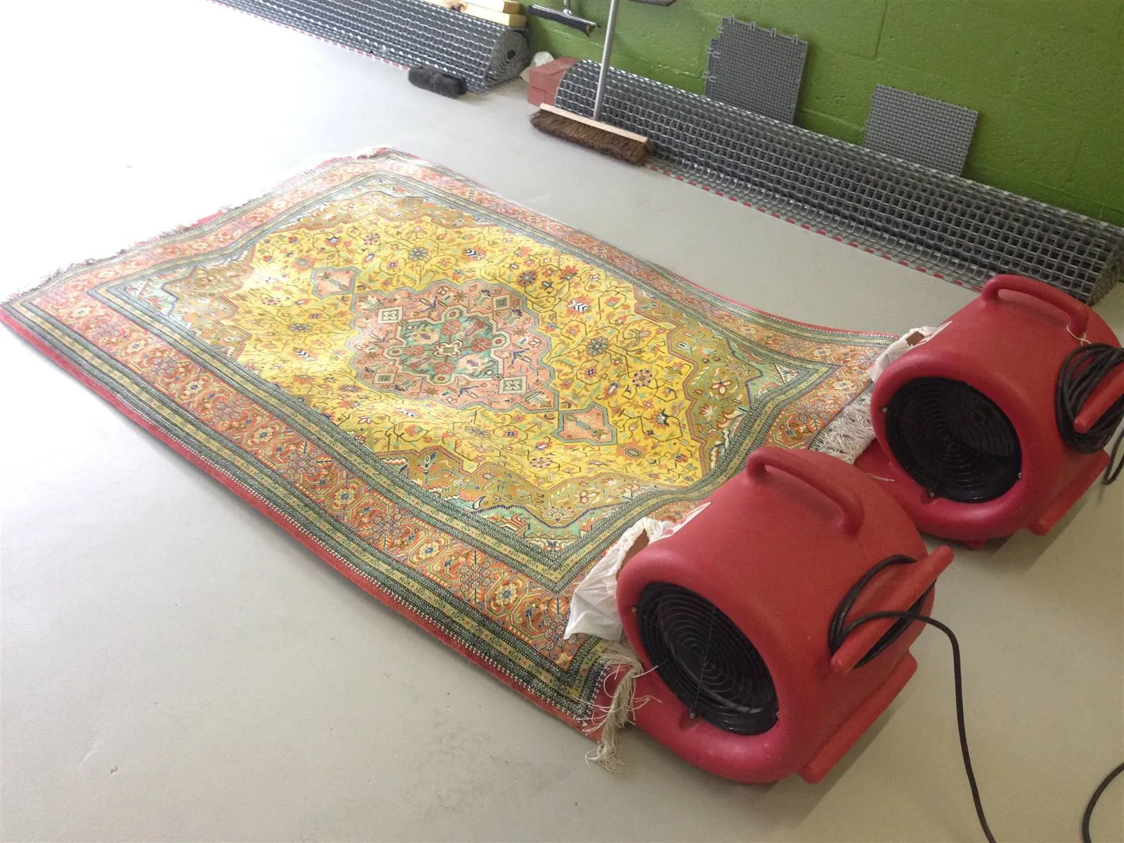 Silk rug drying flat under air movers in the controlled drying room